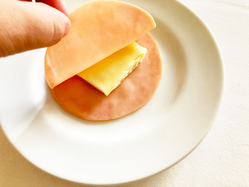 チーズをハムに挟む